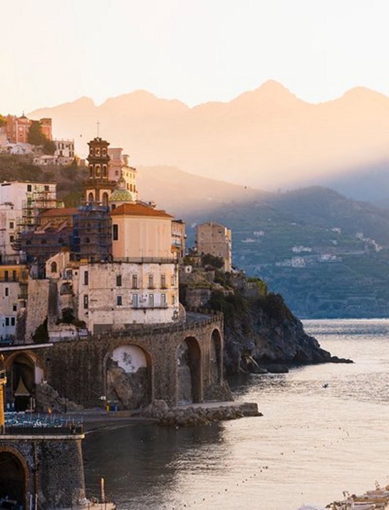 Ein ruhiger Wasserbereich mit sanften Wellen, umgeben von einer kontrastreichen Küstenlandschaft.