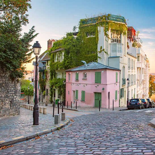 Eine Strasse in Paris mit einer Uhr und einem charmanten Gebäude im Viertel Dorfcharakter.