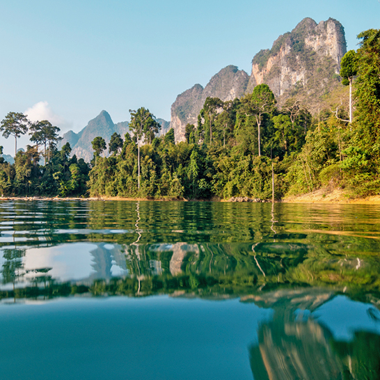 Un lac paisible avec des montagnes majestueuses en arrière-plan, situé dans le parc national de Khao Sok.